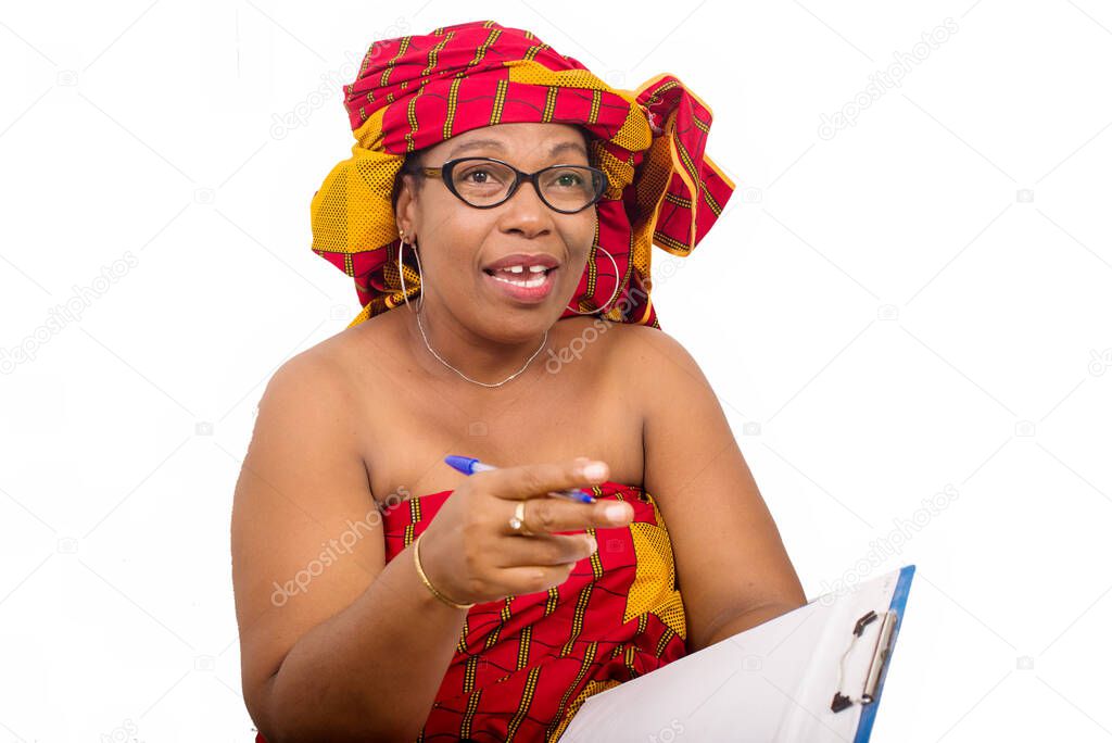 mature woman in loincloth sitting on white background looking at camera smiling with notepad in hand.