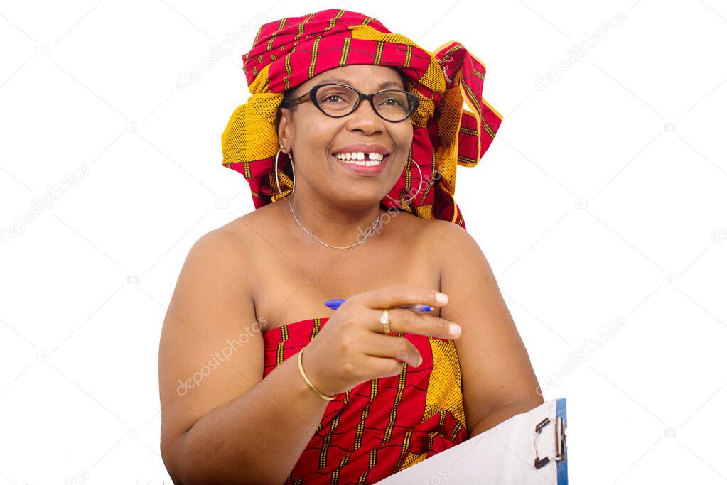mature woman in loincloth sitting on white background looking at camera smiling with notepad in hand.