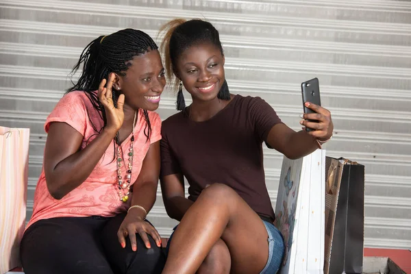 Young Girls Sitting Looking Mobile Phone While Smiling — Stock Photo, Image