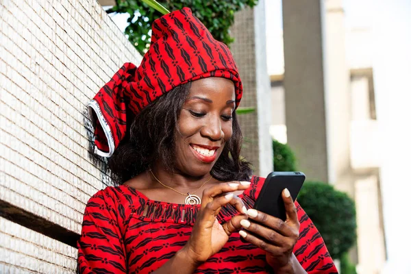 Mature Woman Loincloth Standing Outdoors Looking Mobile Phone While Smiling — Stock Photo, Image