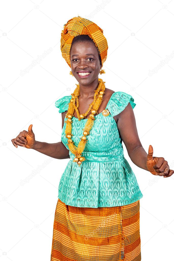 a beautiful young African woman in traditional dress standing on white background dancing and watching the camera smiling.