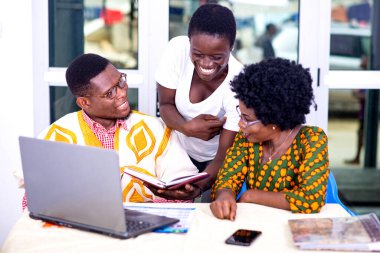 Yetişkin iş ortakları, raporları ofiste birlikte kontrol ediyorlar, gülümsüyorlar..