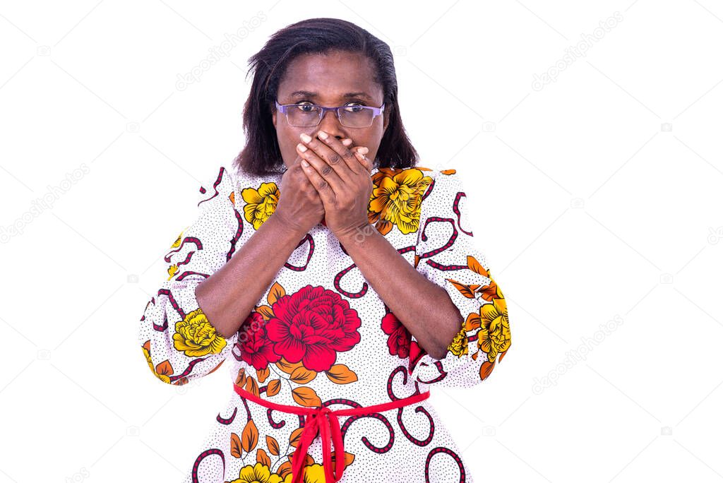 Surprised adult woman wearing glasses and covering mouth with hands while looking at camera.