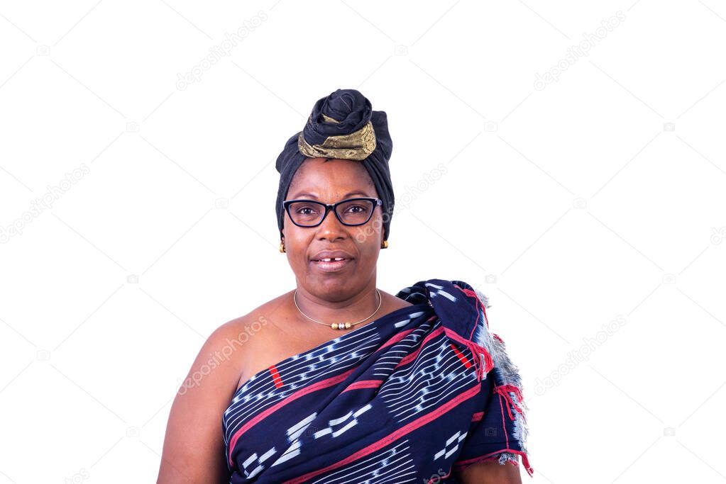 a beautiful african woman in traditional dress standing on white background talking and looking at the camera.