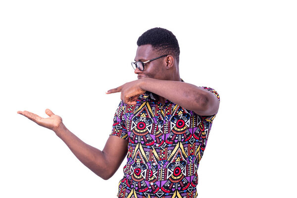 A young man in glasses standing on white background presenting hand gesture