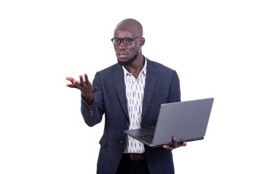 a young businessman in jacket standing on white background holding a laptop and making hand gesture with pissed off look.