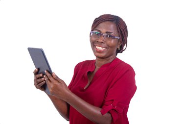 Gözlüklü güzel bir iş kadını beyaz bir arka planda elinde tabletle kameraya bakıp gülümsüyor..