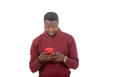 portrait of a handsome young man chatting on the mobile phone while smiling.