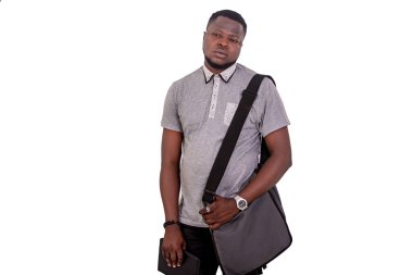 worried young man with a bag over his shoulder holding a digital tablet.