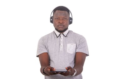 portrait of a handsome serious young man wearing a helmet and holding a digital tablet while looking at the camera.