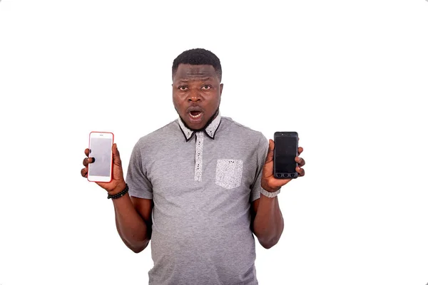 Portrait Handsome Young Man Surprised Showing Two Mobile Phones While — Stock Photo, Image