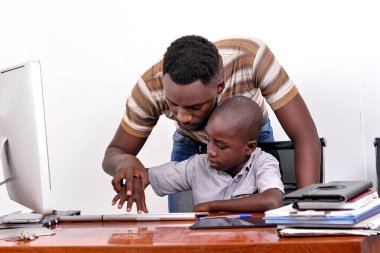 portrait of a young father teaching his little boy to use a laptop computer at home. clipart