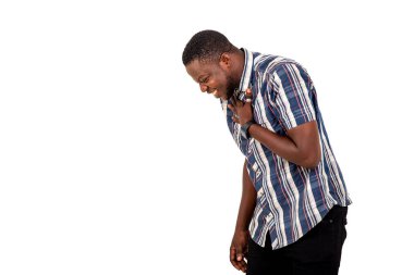 Beyaz bir arkaplanda duran ve eli göğsünde gülen yakışıklı bir gencin portresi..