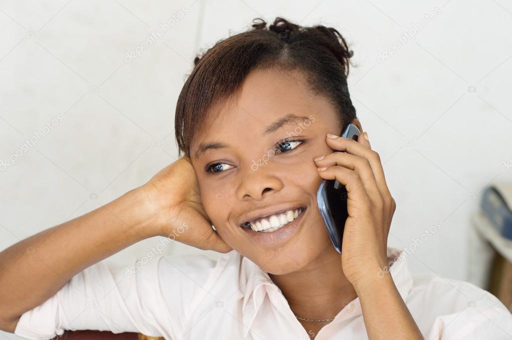 young woman on the phone smiling.