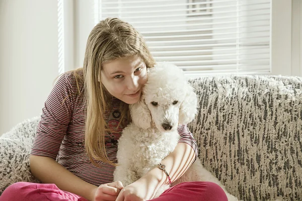 Chica con un perro en la cama — Foto de Stock
