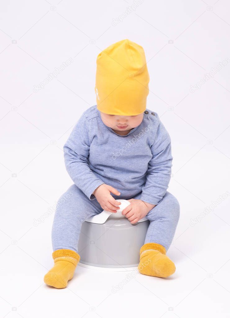 Potty training, adorable infant on a white background