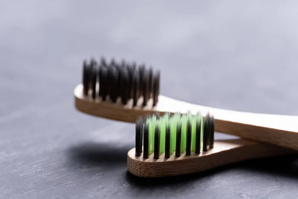 Bamboo tooth brushes on black background