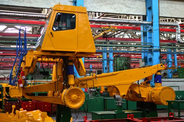 Production process of heavy mining trucks at the factory. Dump truck on the Industrial conveyor in the workshop of an automobile plant. Manufacturer of haulage and earthmoving equipment, haul trucks.