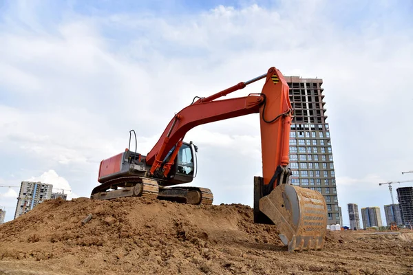 Digging the pit foundation a hole with excavator. Earthwork in excavation and backfilling of soil upto required depth is required for construction of trenche. Construction machinery for earthmoving