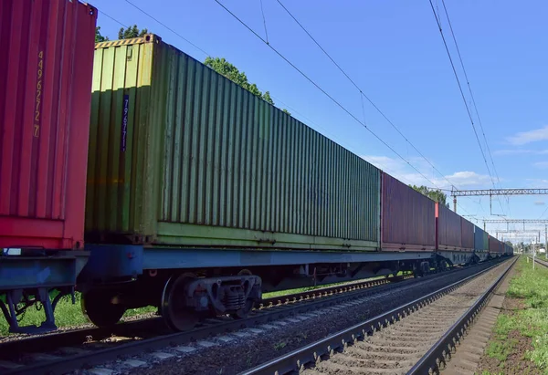 Cargo Containers Transportation On Freight Train By Railway. Intermodal Container On Train Car. Rail Freight Shipping Logistics Concept. Import - export goods from China.