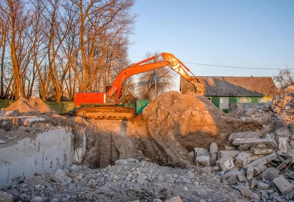 Excavator with hydraulic breaker hammer for the destruction of concrete and hard rock. Jackhammer using without blasting method. Hard rock demolition