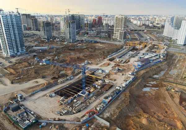 Tower crane and gantry crane working at construction site. Digging pit for building of underground tunnel of metro Aerodromnaya in Minsk, Belarus 31.03.2021. Project \'Minsk World\' by Dana Holdings