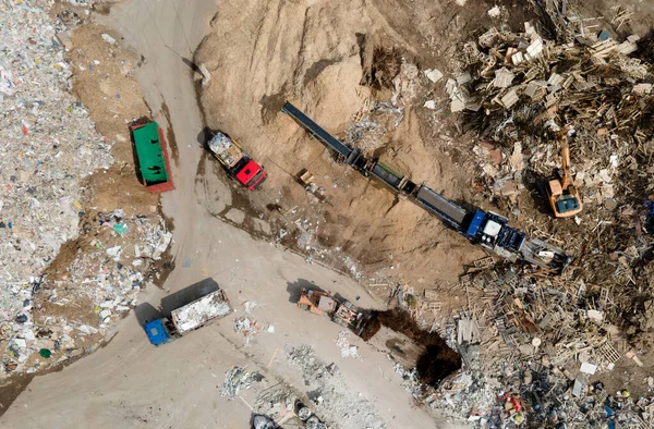 Landfill for the recycling of construction waste and dispose debris. Industrial rubbish treatment processing factory. Garbage dump with plastic bags and food waste. Trash disposal at junk yard.