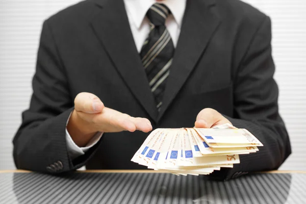 Businessman shows that you take money and accept the deal. finan — Stock Photo, Image