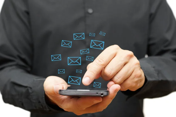 Hombre joven usando el teléfono inteligente con iconos de correo electrónico alrededor — Foto de Stock