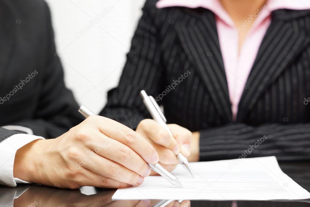 Woman and man are analyzing and fulfilling document