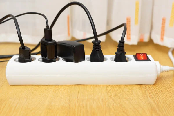 Many electrical appliances pluged in surge protector. Power cons — Stock Photo, Image