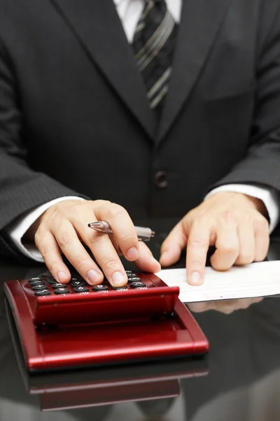 Businessman calculating expenses — Stock Photo, Image