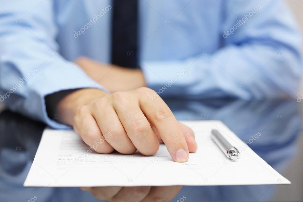 businessman show client where to sign