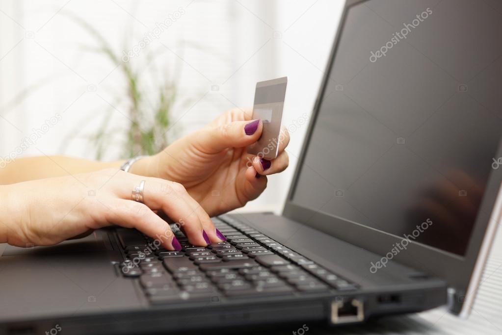 Businesswoman is using laptop for on line payment with credit ca