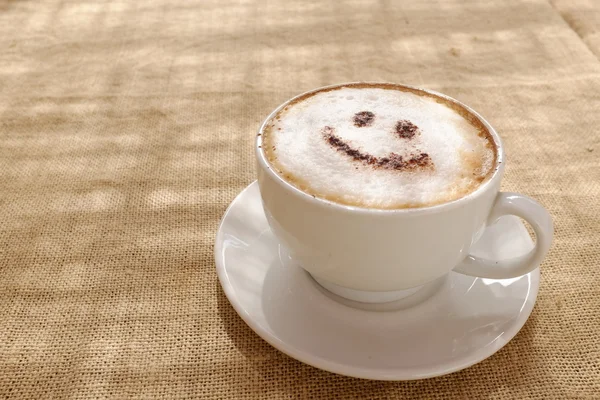 Coffee cappuccino foam or chocolate smiling happy face