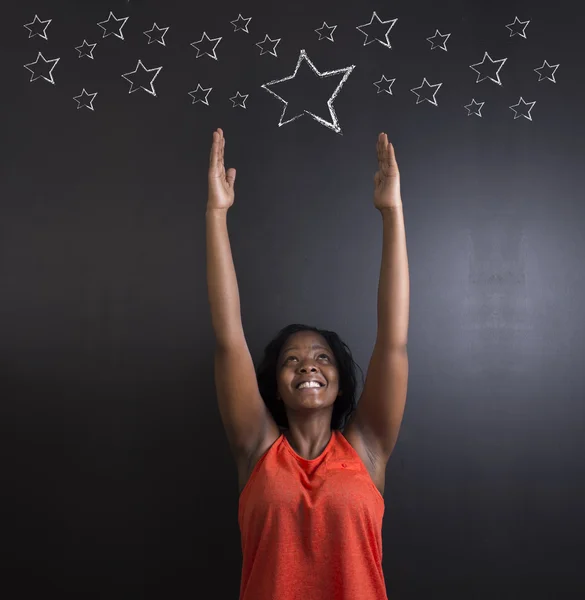 South African or African American woman teacher or student reaching for the stars success — Stock Photo, Image