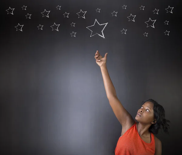 South African or African American woman teacher or student reaching for the stars success — Stock Photo, Image