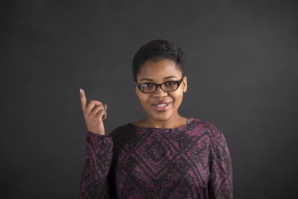 African woman good idea on blackboard background — Stock fotografie