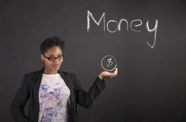 African woman holding hand out showing money on blackboard background — Stok fotoğraf