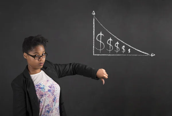 African woman with thumbs down hand signal to decrease in money on blackboard background — Stock Photo, Image