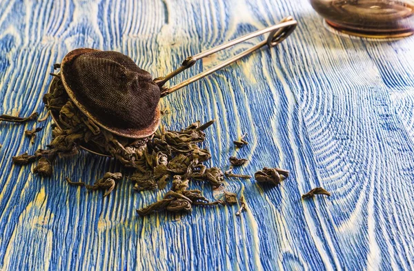 Leaf tea strainer and tea leaves. — Stock Photo, Image