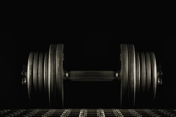 Dumbbell on a dark background. — Stock Photo, Image