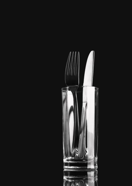 Cutlery, glare on a dark background. — Stock Photo, Image