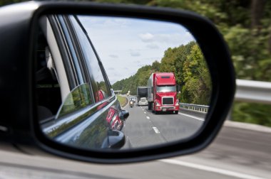 Traffic In Mirror On Highway clipart