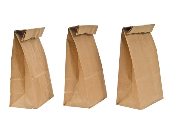 Tre vikta topp bruna papperspåsar — Stockfoto