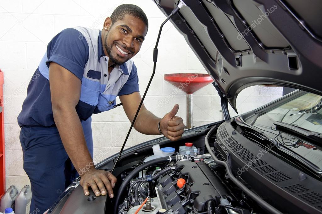 Auto Mechanic Smiling And Giving Thumbs Up