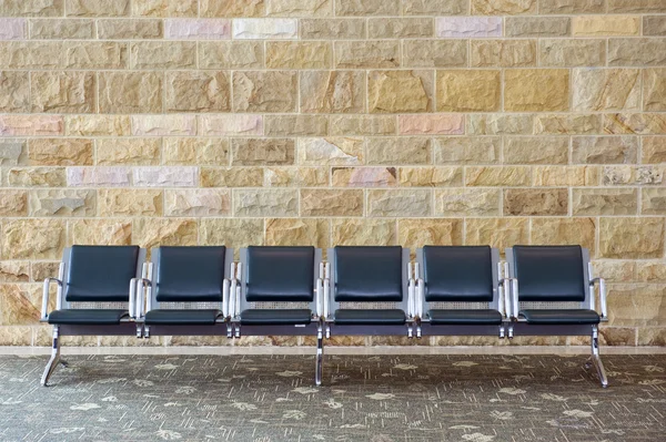 Row Of Empty Seats Against A Brick Wall — Stock Photo, Image