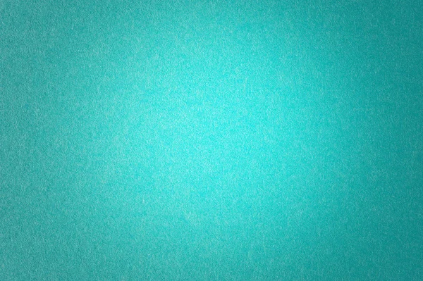 Turkusowy niebieski papier teksturowanej tło zapalniczki w centrum — Zdjęcie stockowe