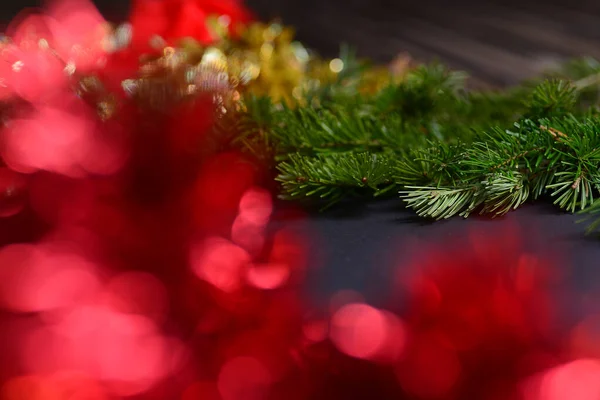 Orange beads with round beads to decorate the Christmas tree, close-up against a background of blurred red light from the lamps. — Stock Photo, Image