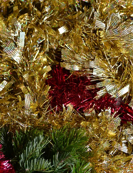 Festive background with gold and red tinsel, green spruce branches. Vertical. — Stock Photo, Image